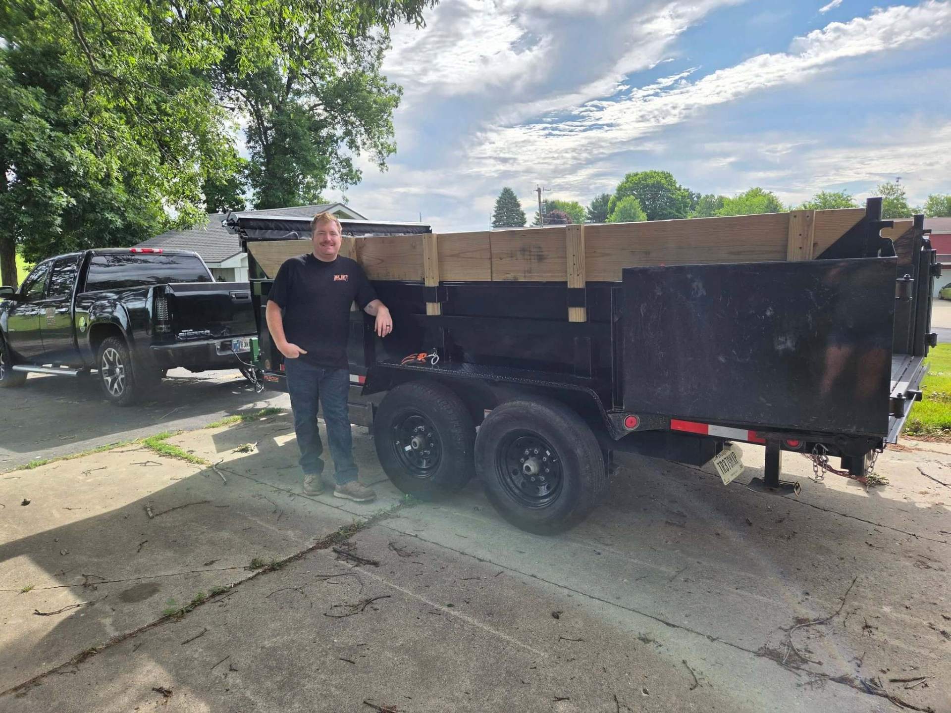 Dylan, owner of Hoosier Junk Removal & Clean-Up, with his truck and dump trailer